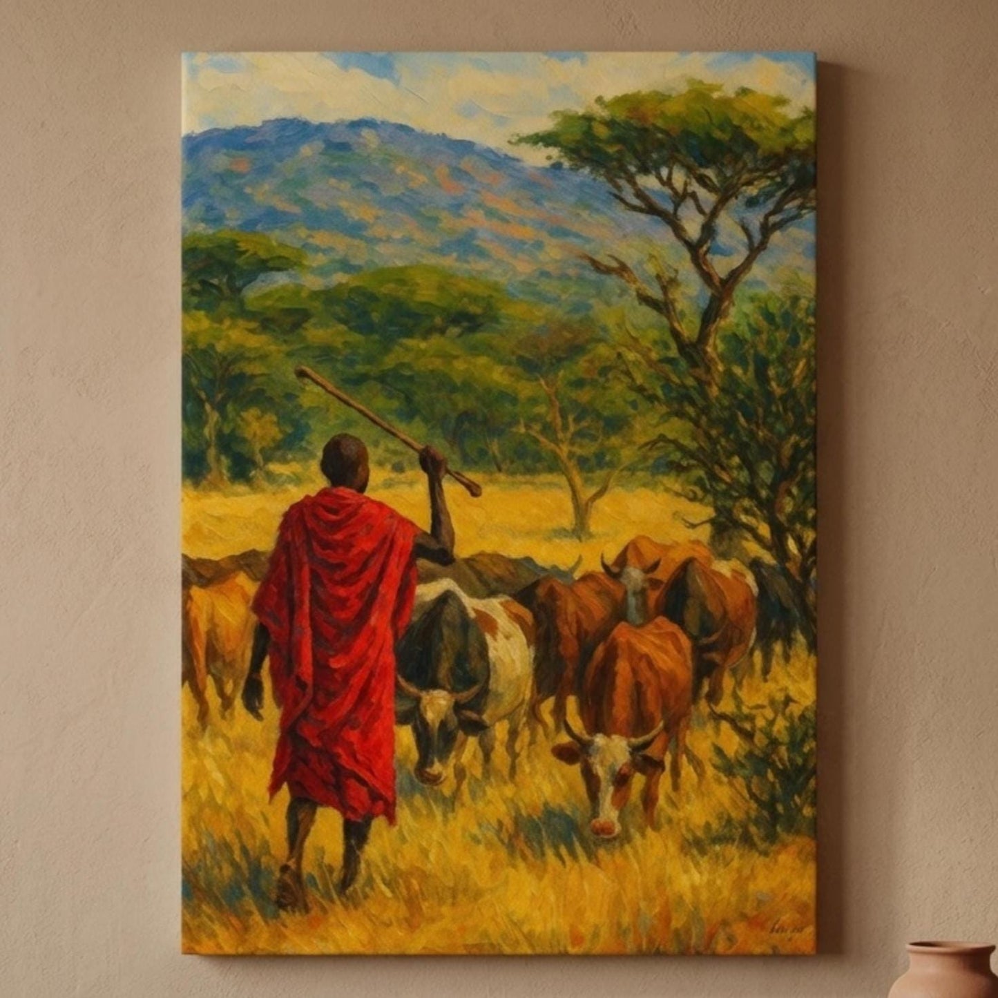 Canvas wall art of a Maasai herder in a red shuka leading cattle through golden savanna grass, impressionist style, hung above a rustic wood console with a woven basket and terracotta vase on a beige wall.