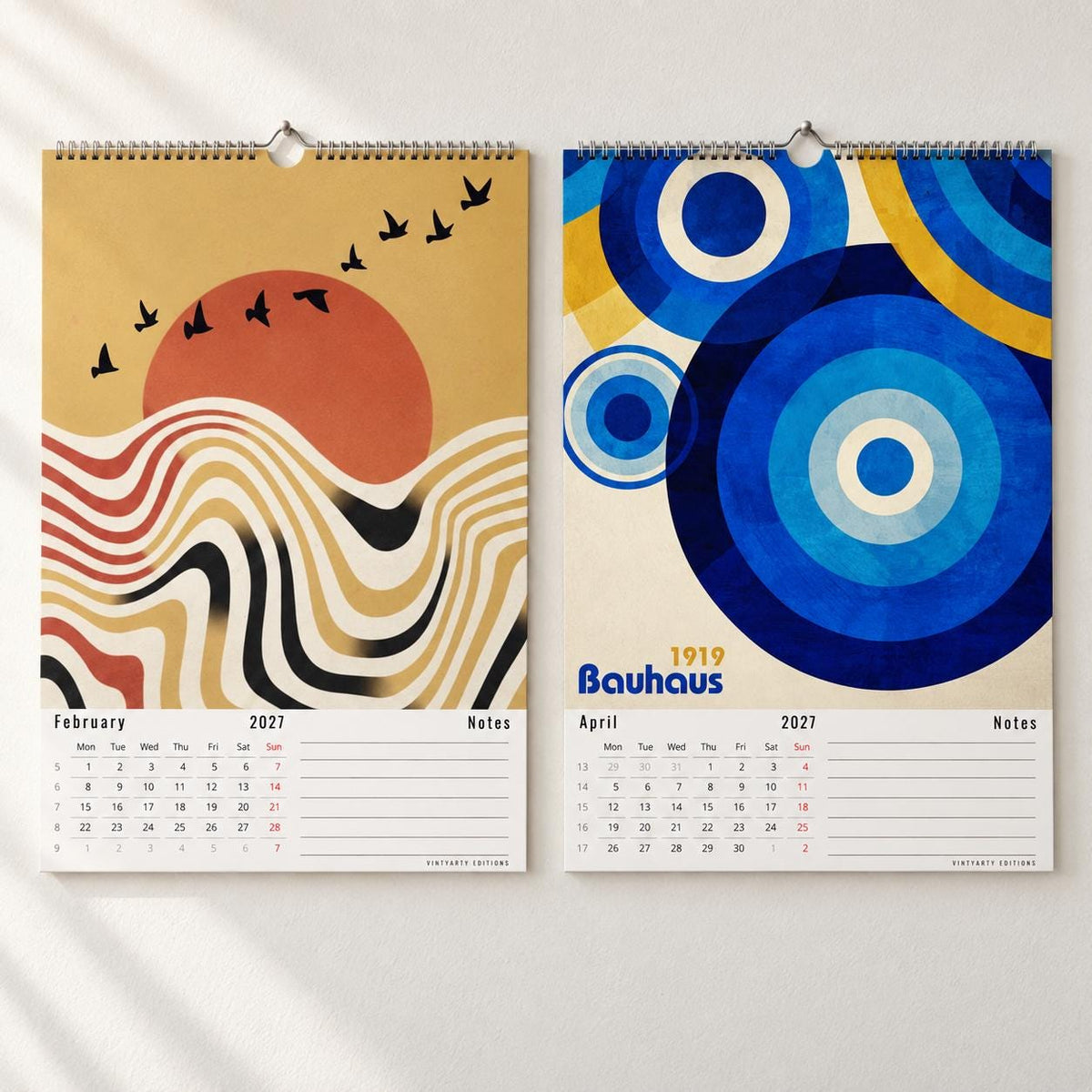 February and April pages of the 2027 wall calendar, geometric sunset and blue Bauhaus circles